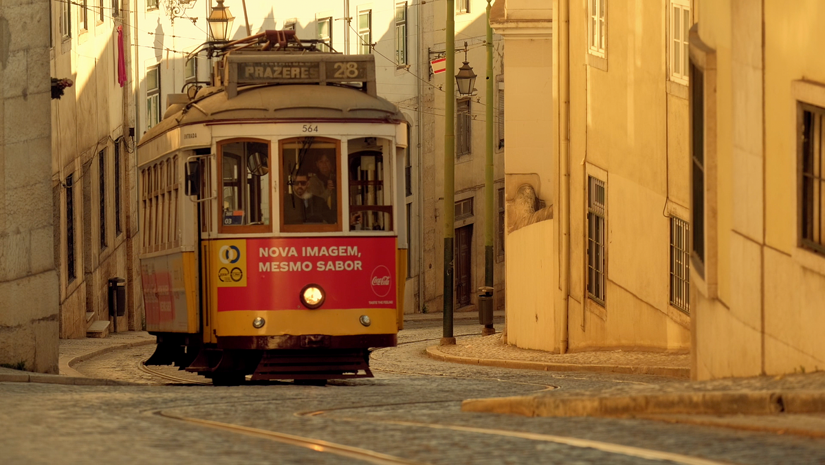 Tram climbs steep hill in Lisbon at dawn By Jason Row Photography.