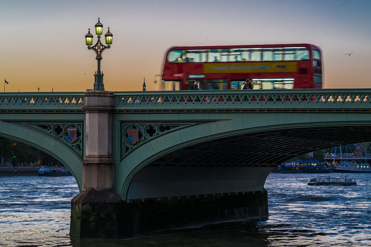 London Bus Crosses Westminster Bridge At Sun Set
