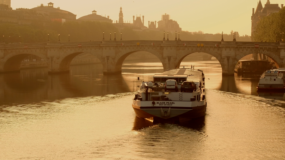 Barge sails the River Seine in Paris at dawn By Jason Row Photography.