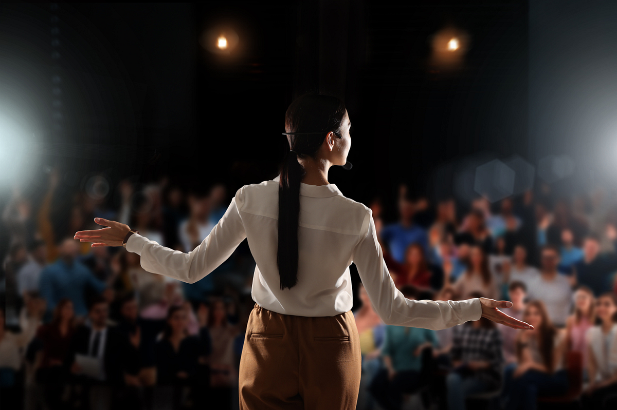 Woman on stage with pony tail from the back