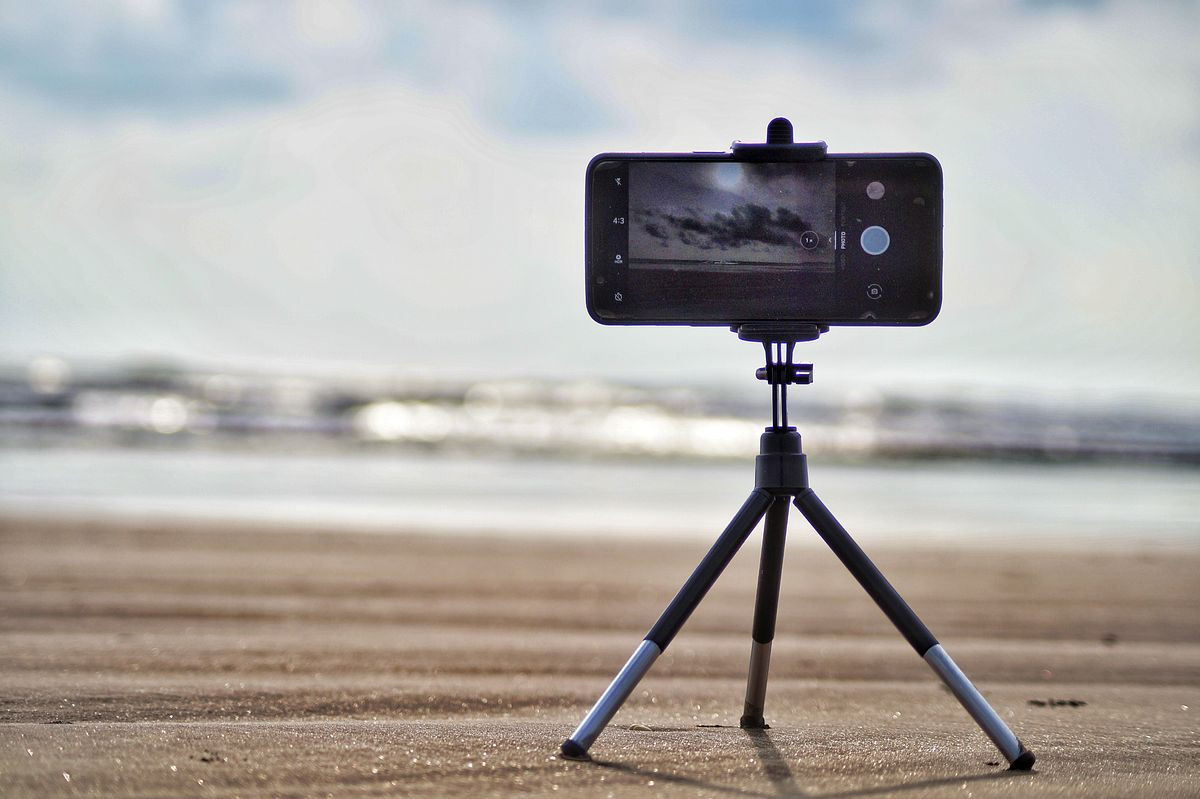 iphone camera on small tripod at the beach