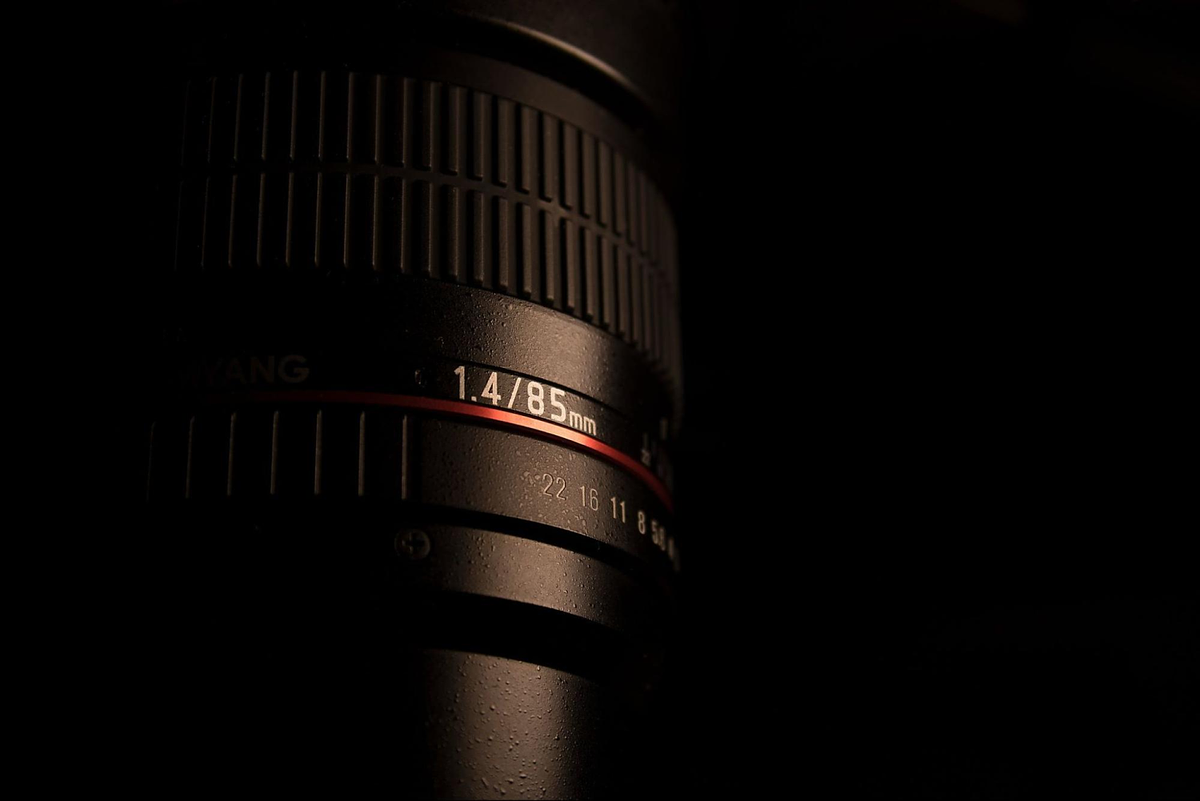 DSLR camera lens in black background