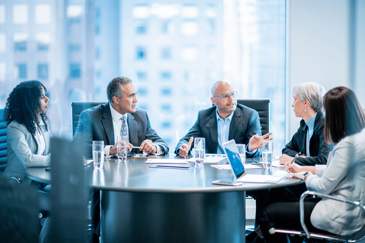 Advisors around table in office setting
